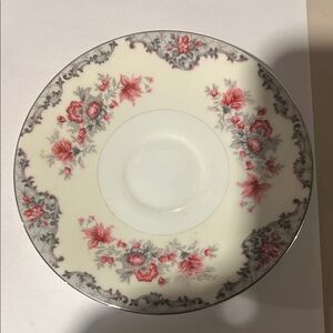 A vintage Meito "Corsage" pattern porcelain saucer with floral decoration.